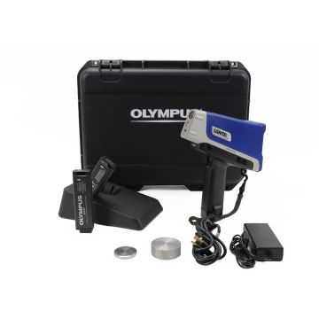 Refurbished Olympus Vanta VCR handheld XRF analyzer with case, dock, batteries, and power adapter.

